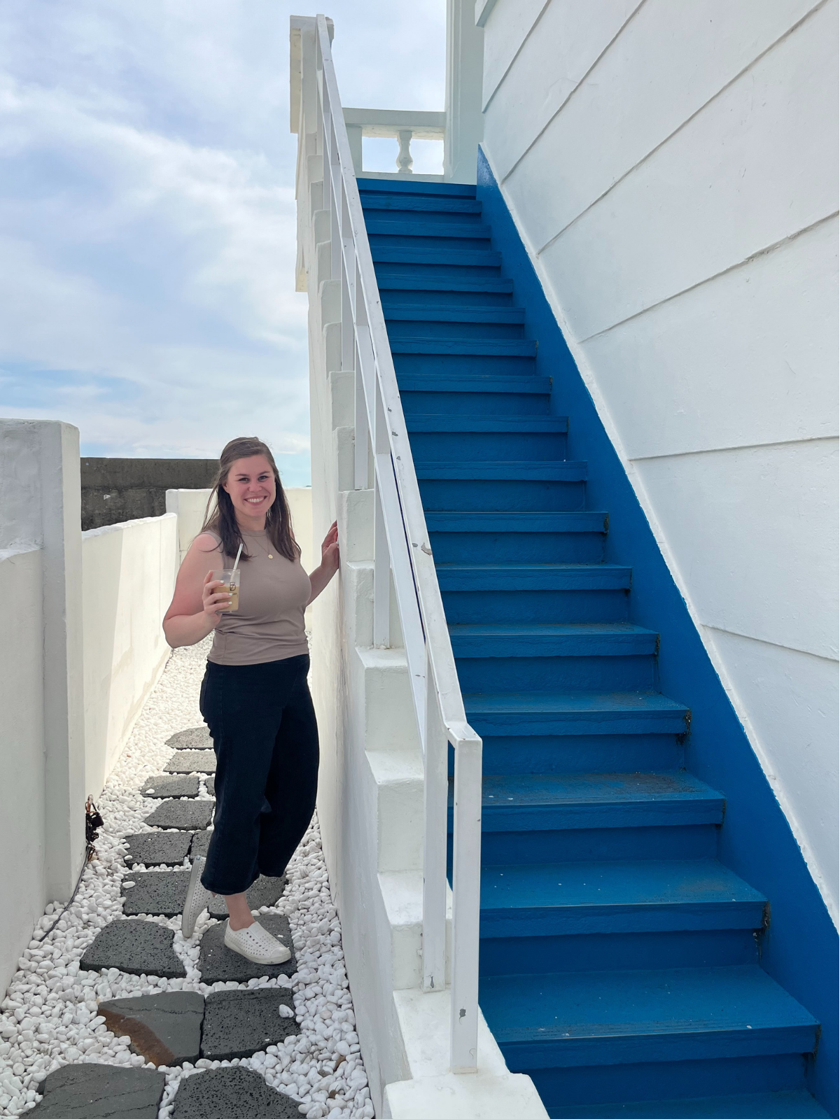 Founder, Addie Dwyer in standing at a blue staircase in Busan, Korea when Sojura was beginning to come about