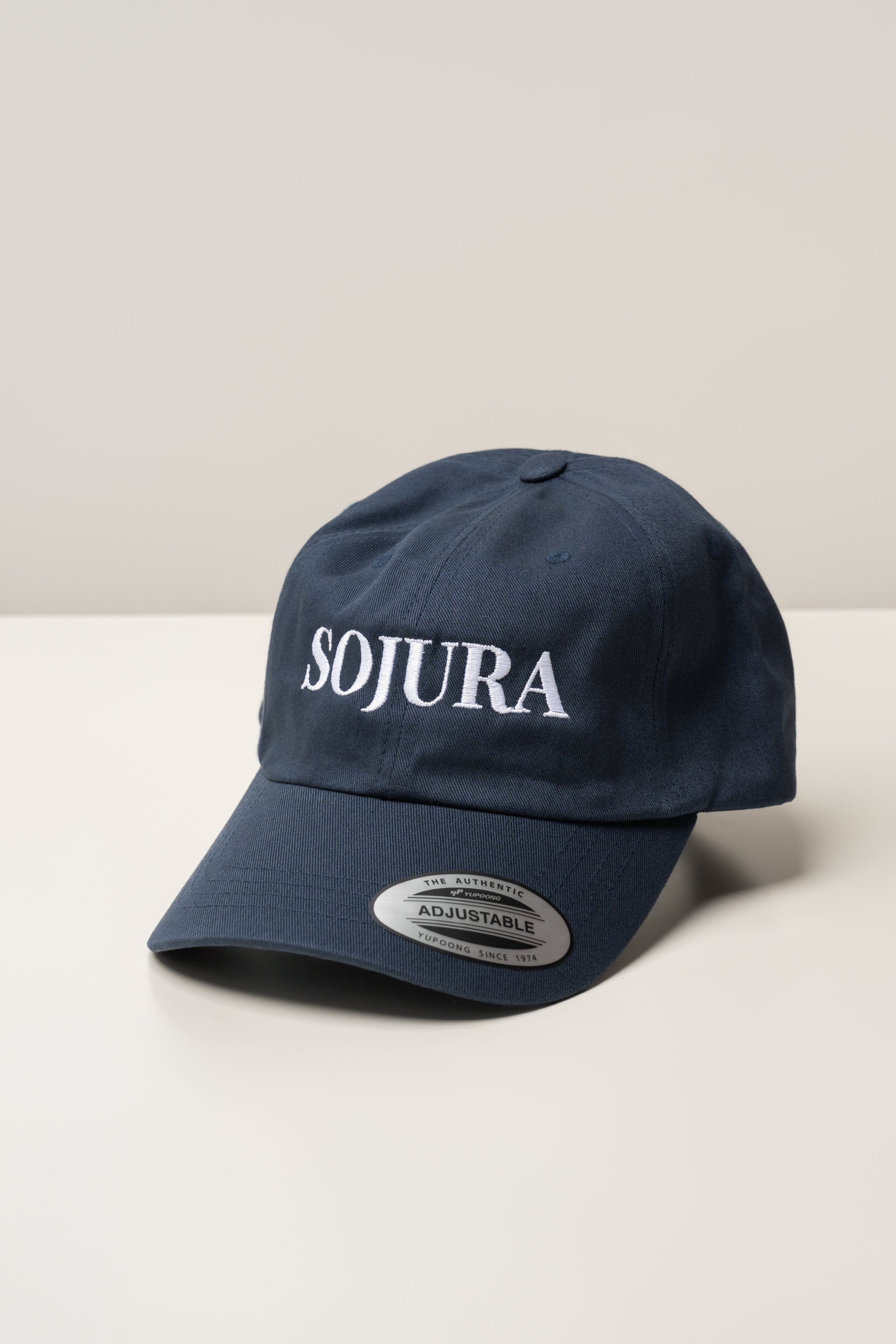 navy ballcap with sojura logo embroidered across the front