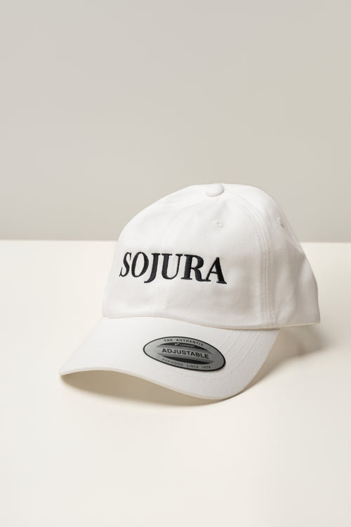 white ballcap with sojura logo embroidered across the front