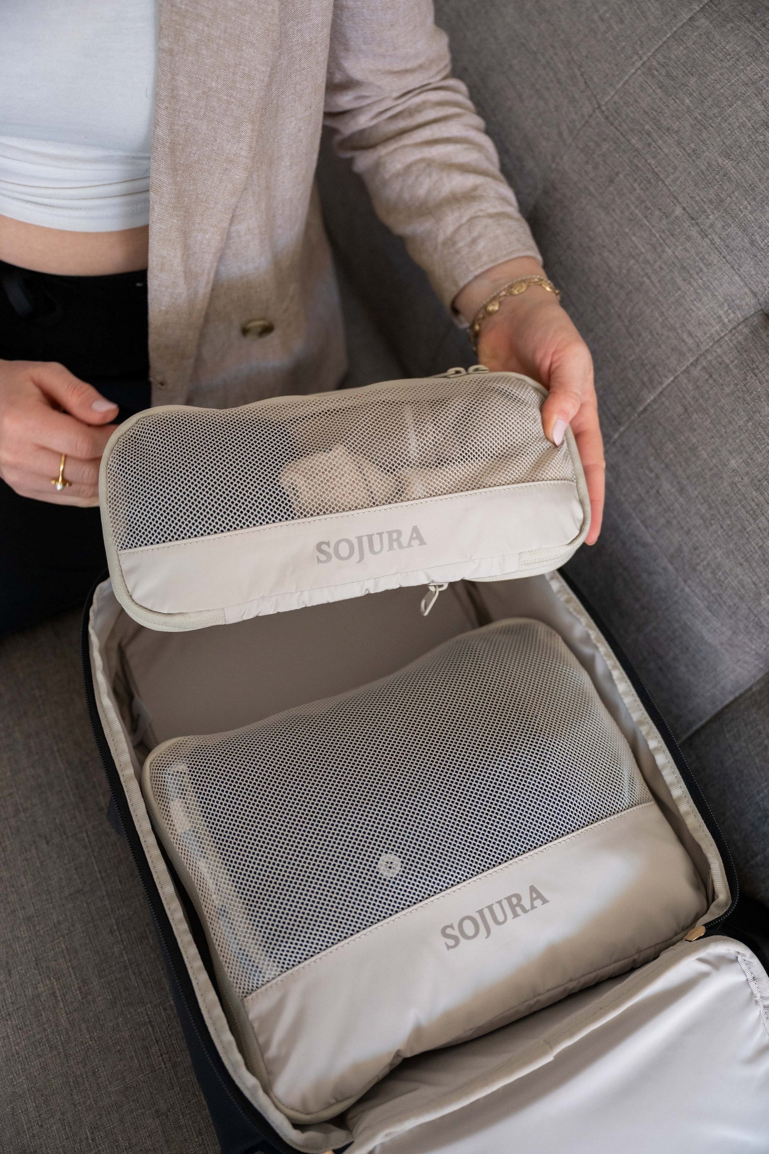 sojura compression packing cubes being packed into sojura womens travel backpack
