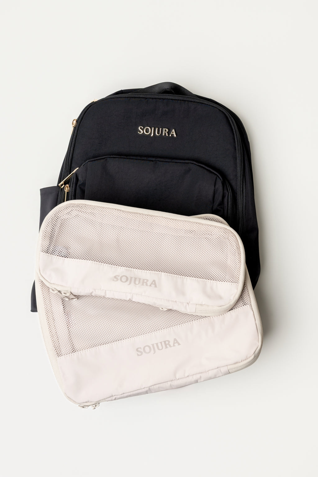 Sojura black Adella backpack with a small sojura compression packing cube and a large sojura compression packing cube as a bundle