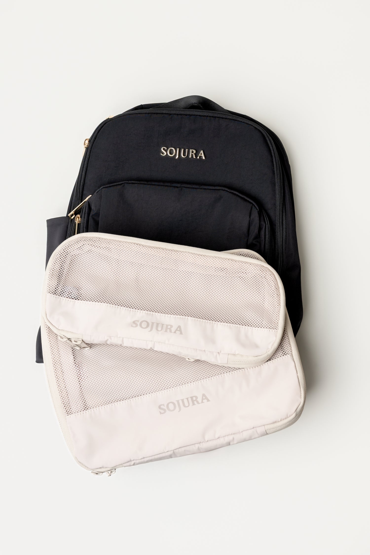 Sojura black Adella backpack with a small sojura compression packing cube and a large sojura compression packing cube as a bundle
